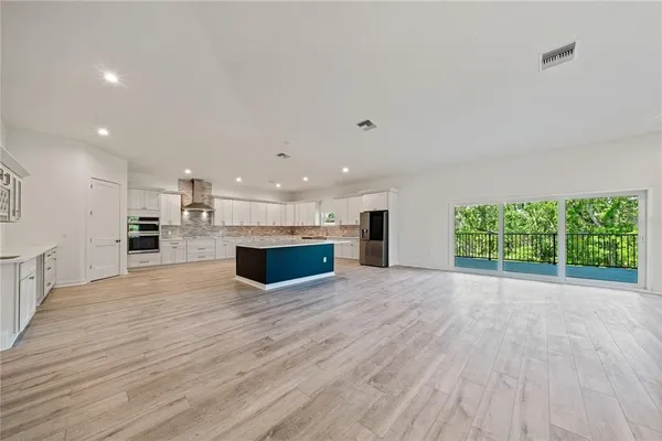 a view of kitchen and kitchen with wooden floor