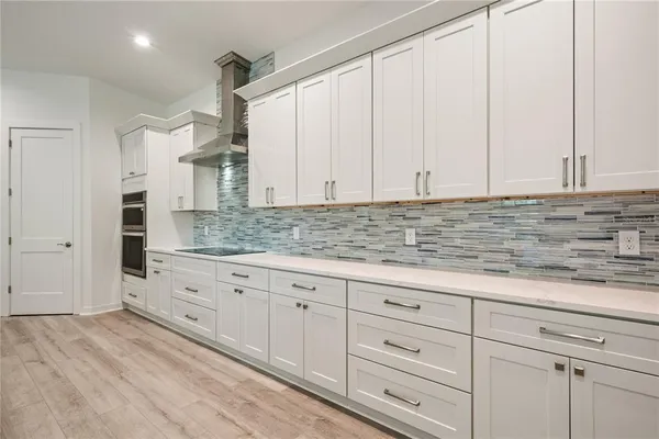 a kitchen with granite countertop white cabinets and sink