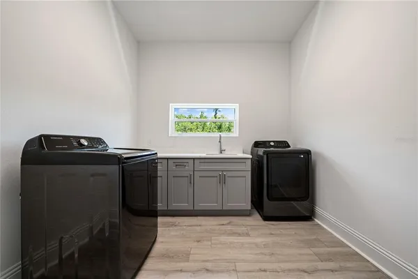 a kitchen with a refrigerator and a stove