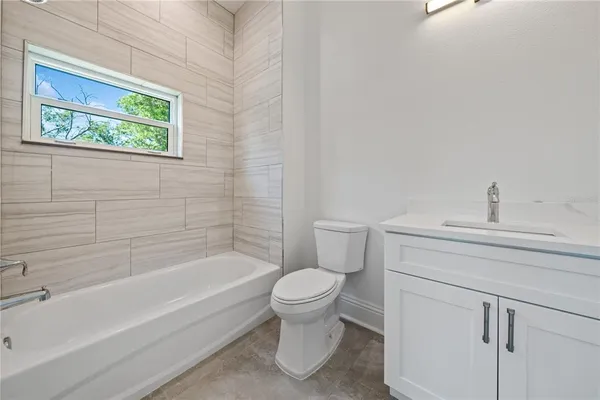 a bathroom with a toilet and a bathtub