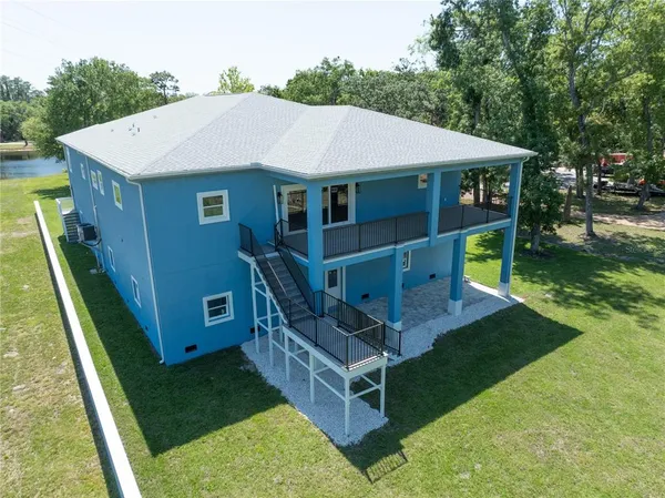 an aerial view of a house with a yard