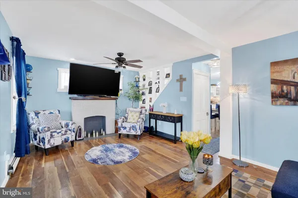 a living room with furniture a flat screen tv and a fireplace