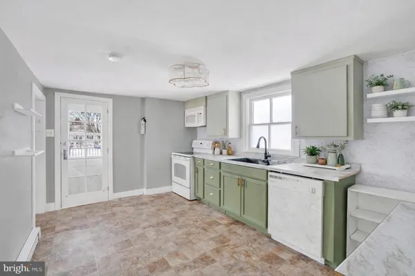 a kitchen with a table and chairs in it
