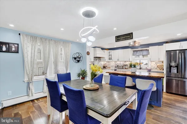 a large kitchen with a table and chairs
