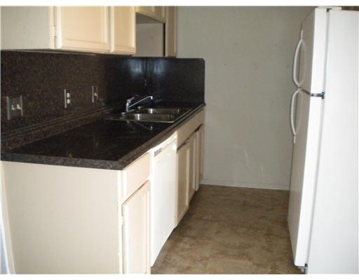 945 Quetzal Street, Unit 3 Corpus Christi, TX 78418 - Photo 2 of 10 a kitchen with a sink and cabinets