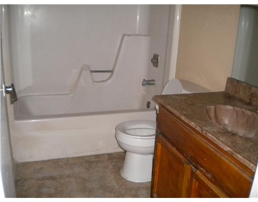 945 Quetzal Street, Unit 3 Corpus Christi, TX 78418 - Photo 6 of 10 a bathroom with a granite countertop sink toilet and shower