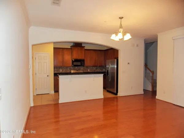 a view of a kitchen with a sink and a refrigerator