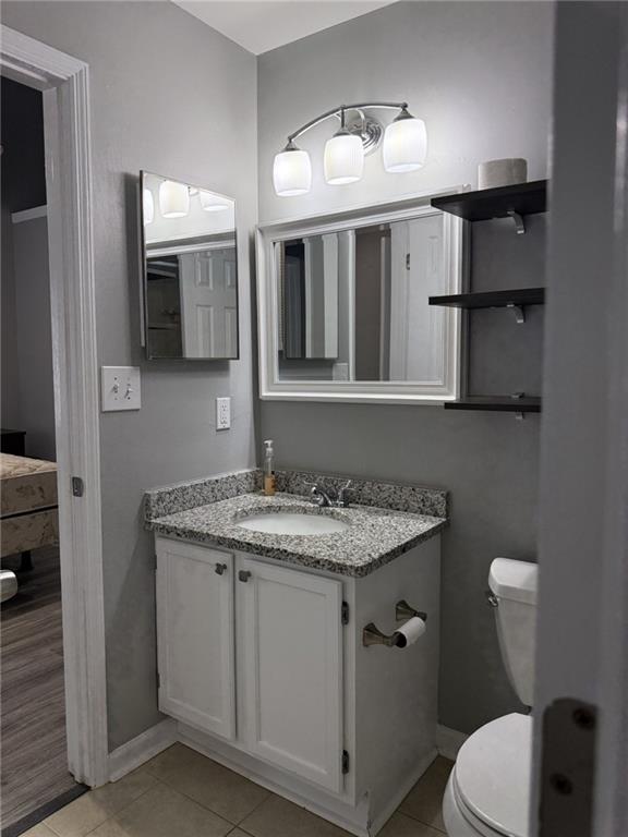 105 Hawkstone Way Alpharetta, GA 30022 - Photo 16 of 23 a bathroom with a granite countertop sink a toilet and mirror