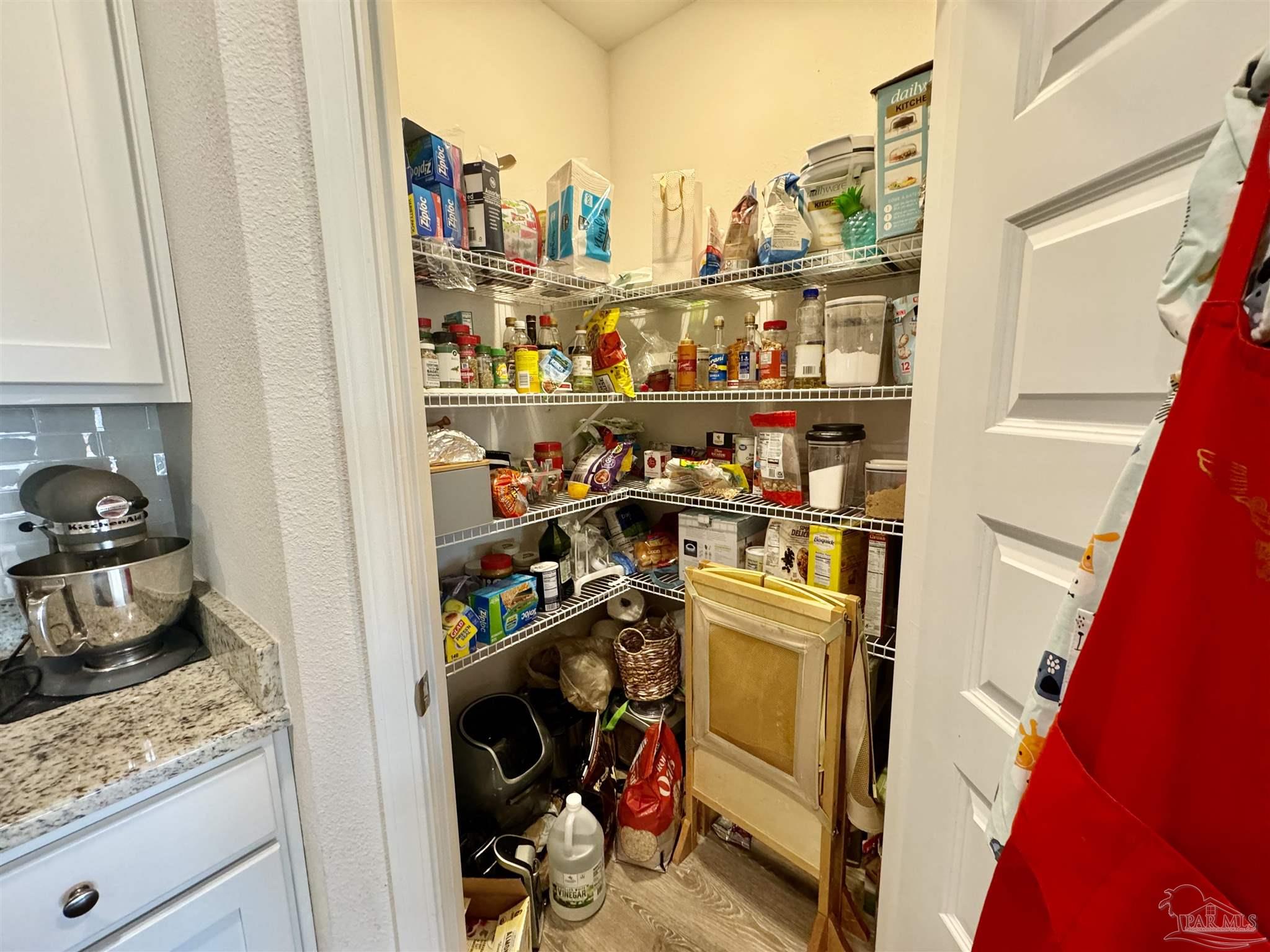 7787 Burnside Loop Pensacola, FL 32526 - Photo 12 of 32 a view of a kitchen with fridge and rack