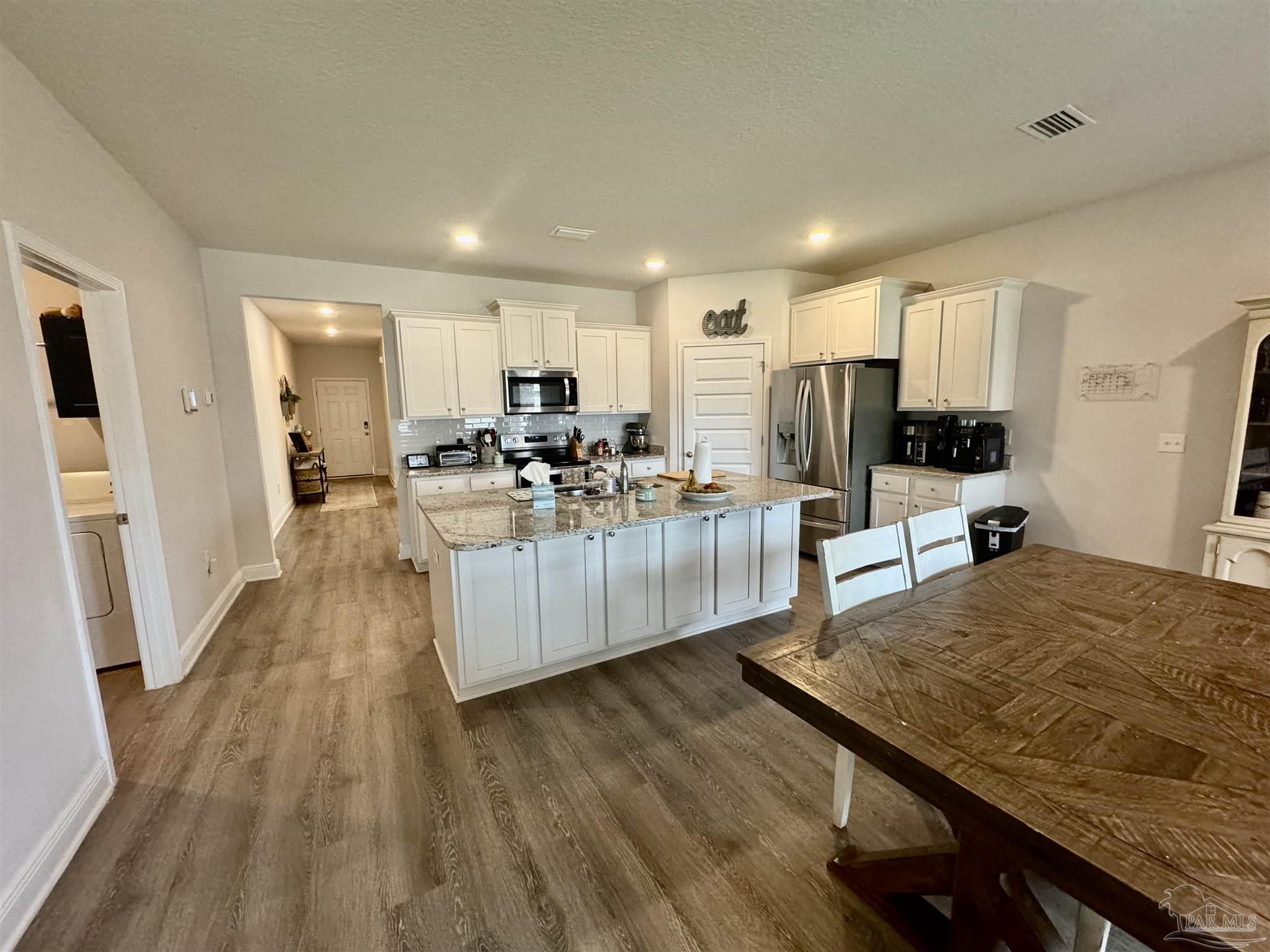 7787 Burnside Loop Pensacola, FL 32526 - Photo 14 of 32 a view of a kitchen and dining room
