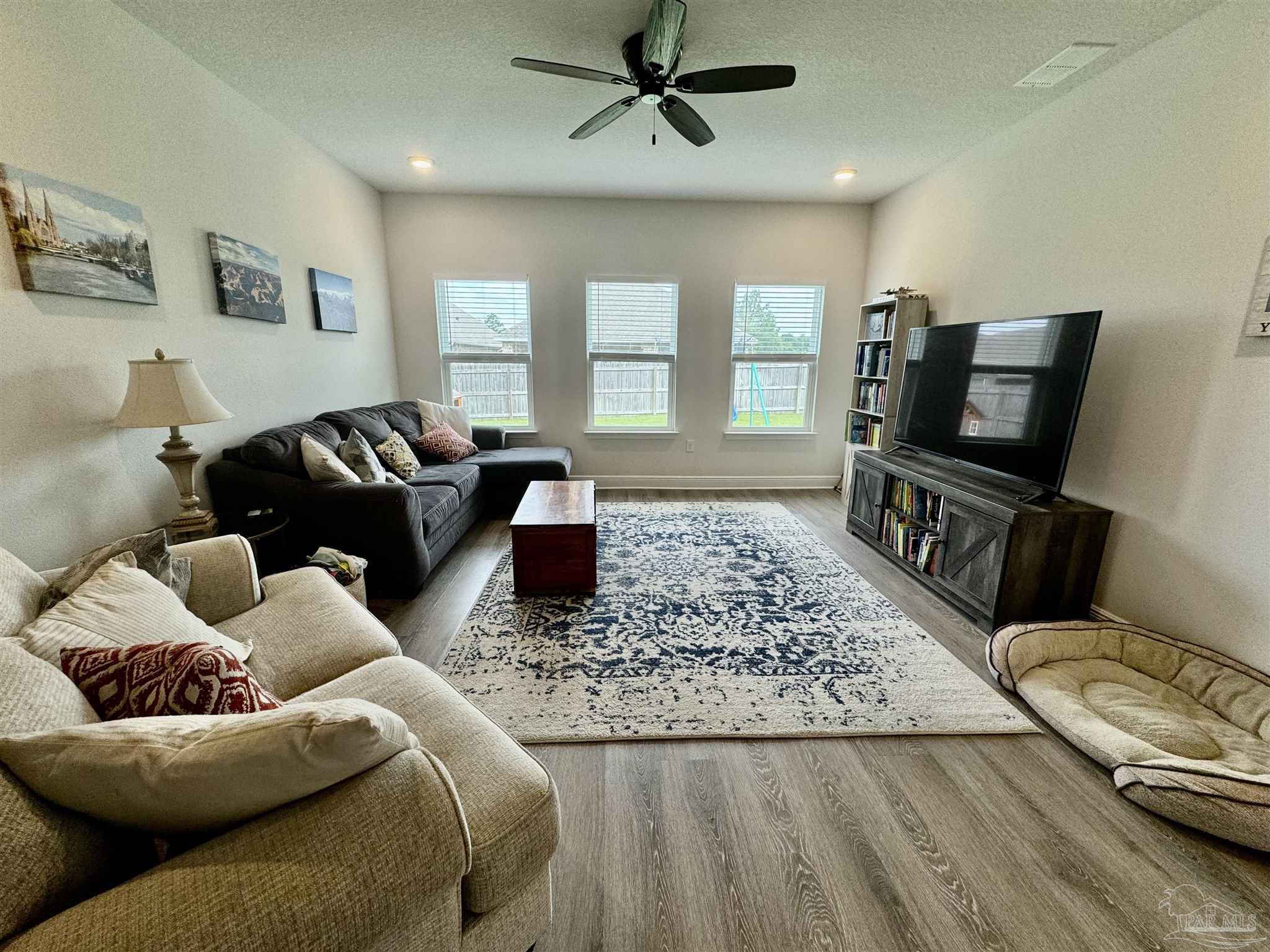 7787 Burnside Loop Pensacola, FL 32526 - Photo 17 of 32 a living room with furniture and a flat screen tv