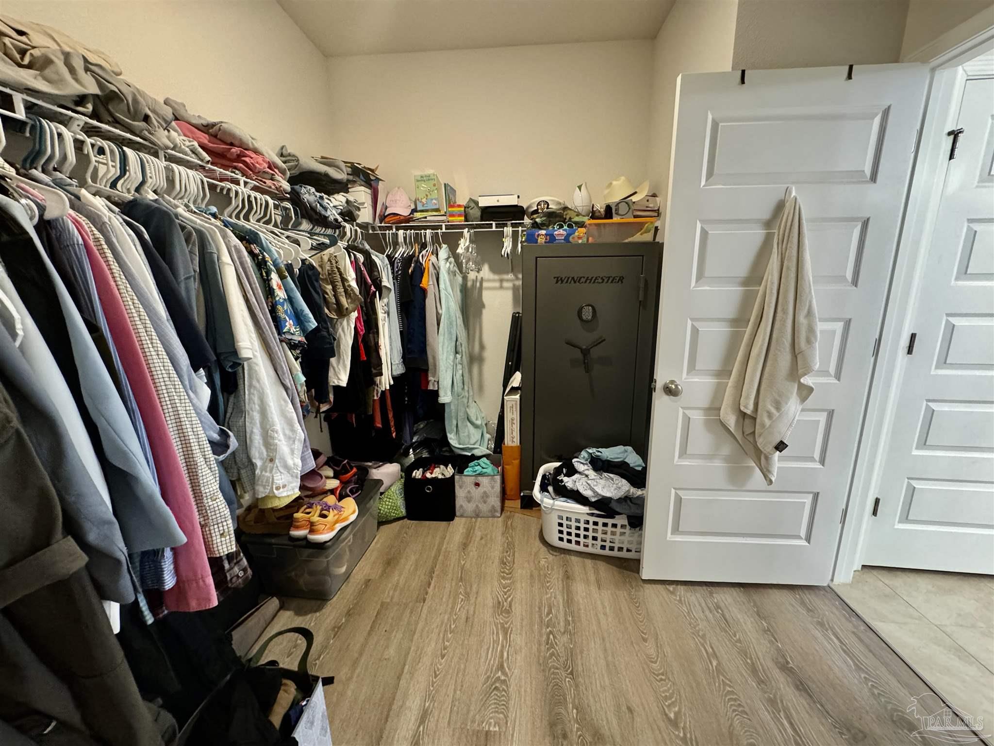 7787 Burnside Loop Pensacola, FL 32526 - Photo 23 of 32 a view of walk in closet with clothes and shoes