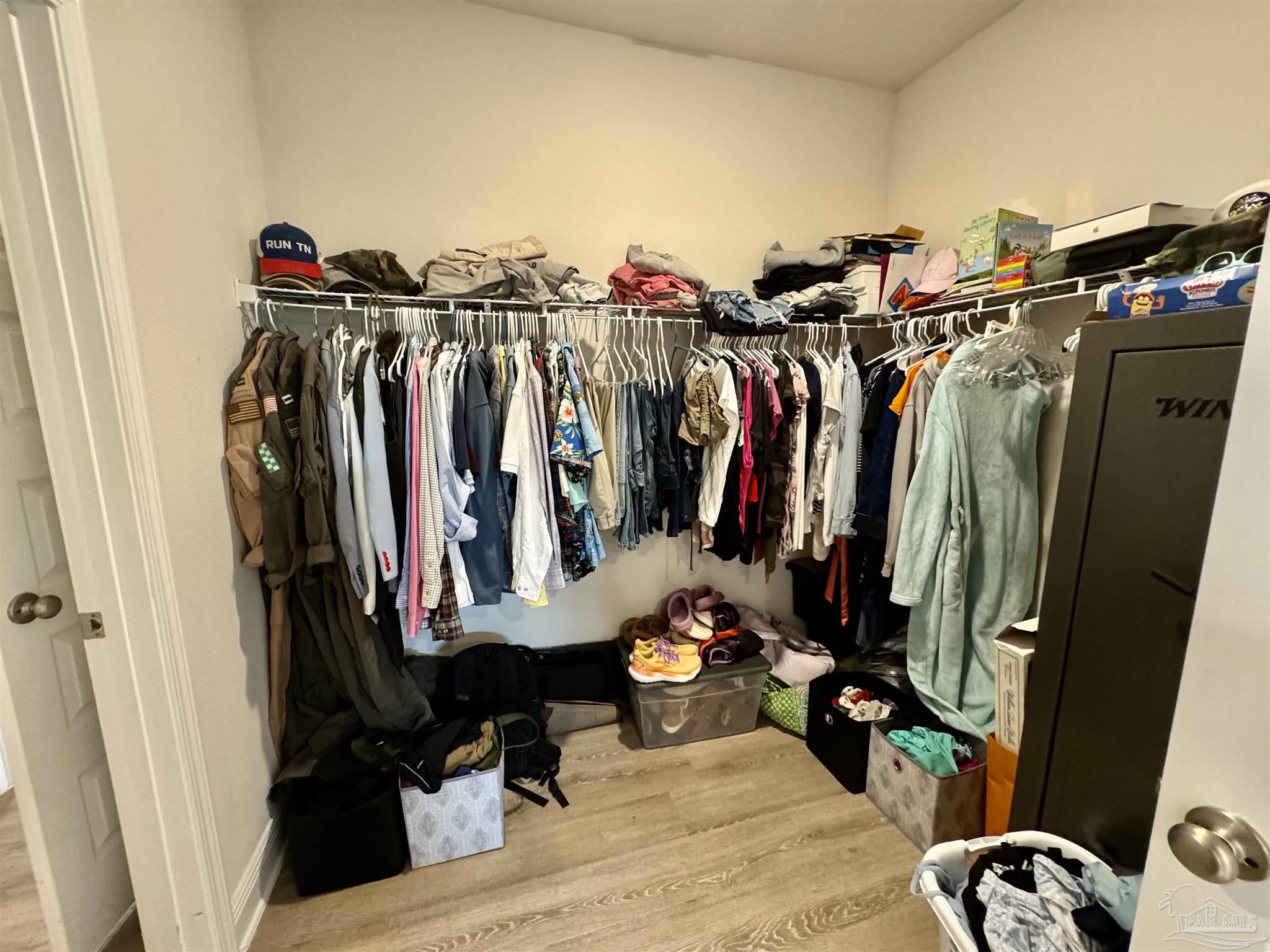 7787 Burnside Loop Pensacola, FL 32526 - Photo 24 of 32 a view of walk in closet with clothes