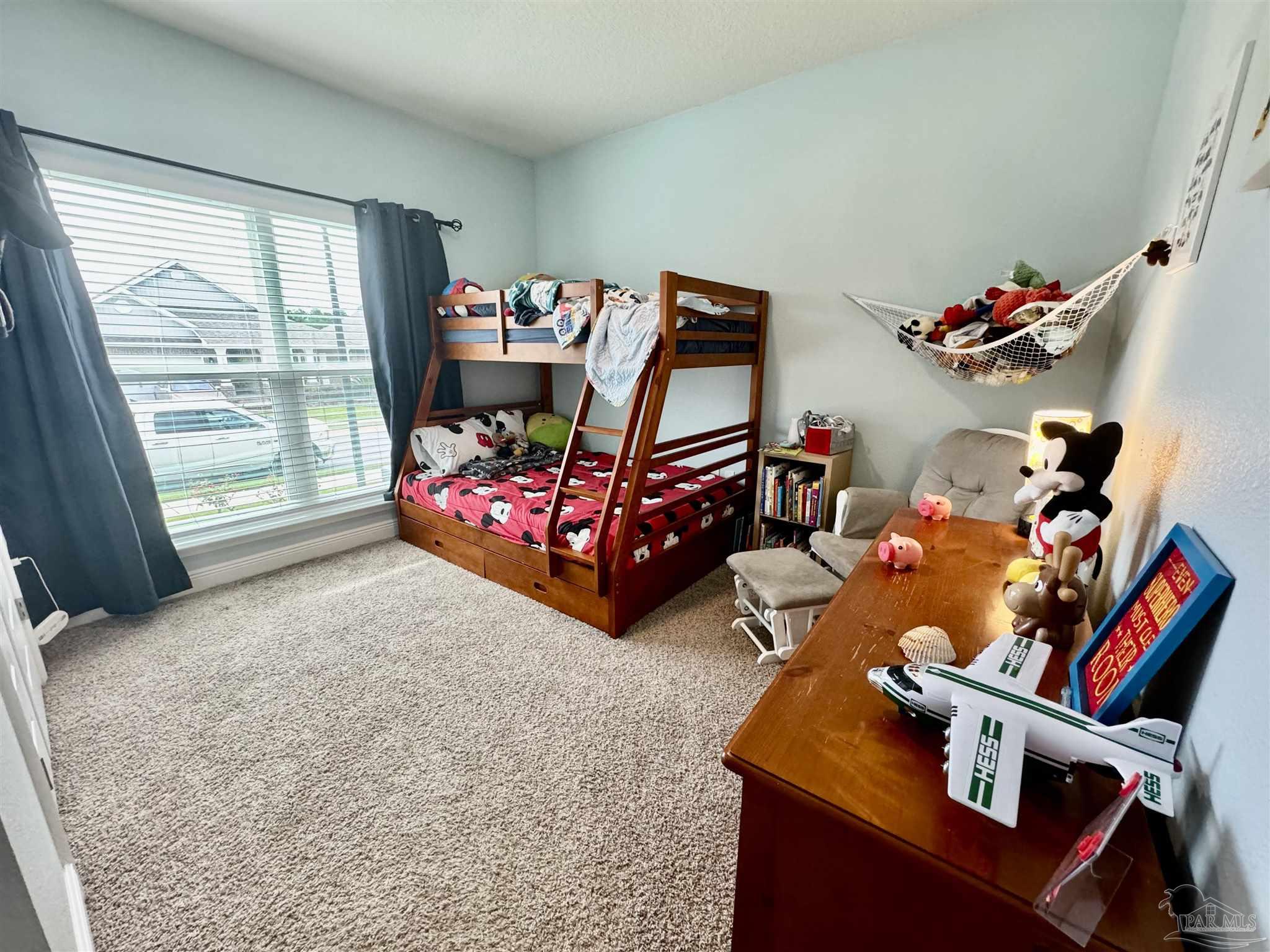 7787 Burnside Loop Pensacola, FL 32526 - Photo 6 of 32 a bedroom with baby bed toys and a large window