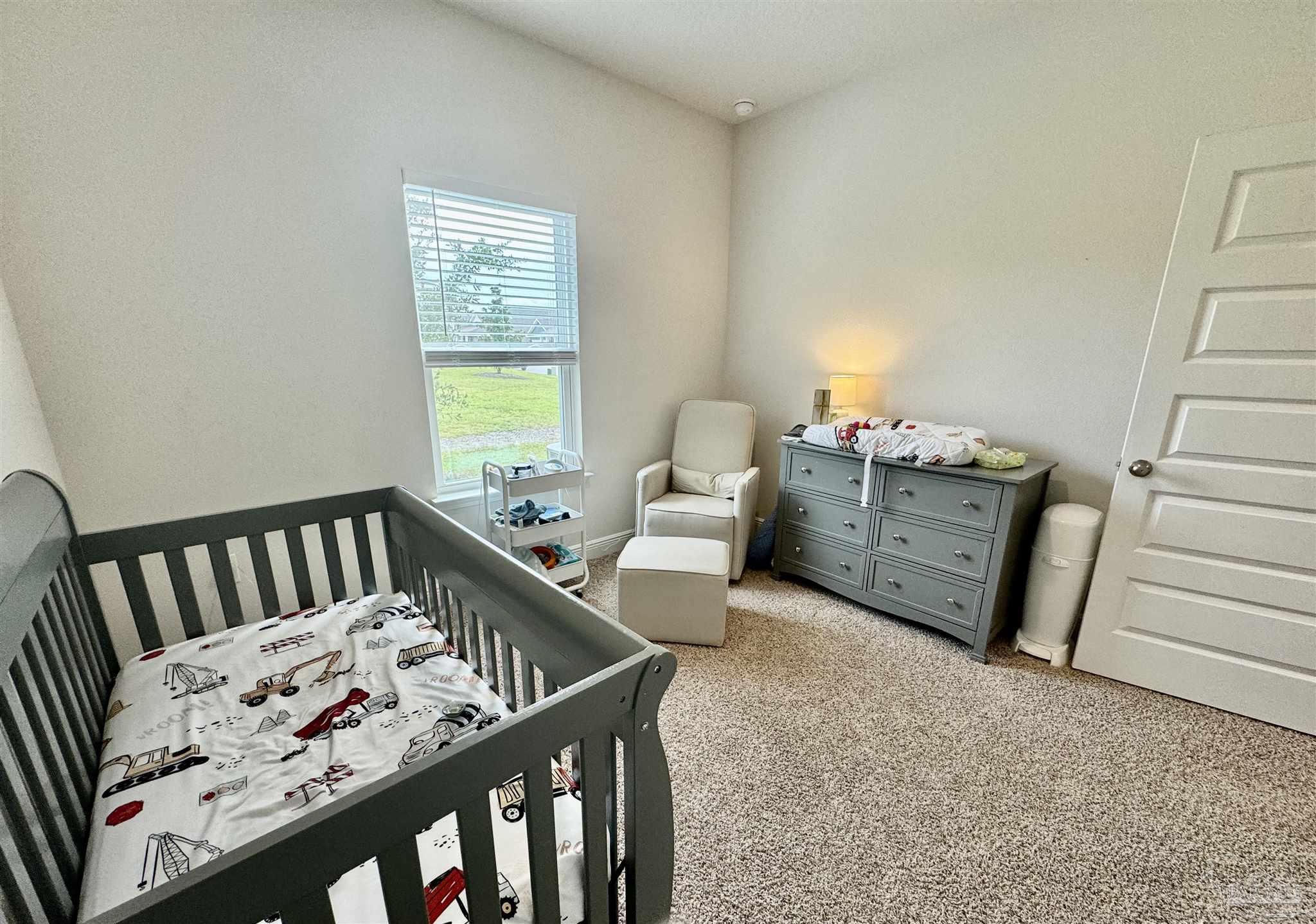 7787 Burnside Loop Pensacola, FL 32526 - Photo 8 of 32 a bedroom with furniture and a window