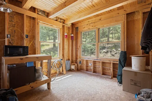 a view of a porch with wooden floor and windows