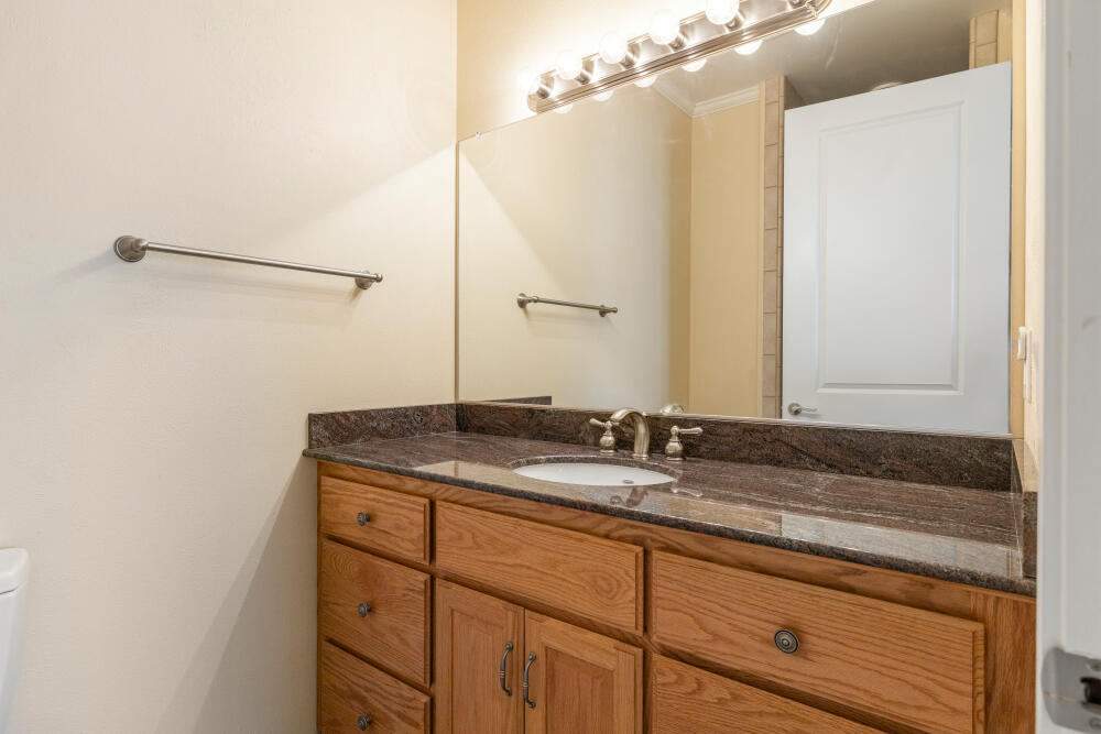 6586 Cooper's Hawk Road Klamath Falls, OR 97601 - Photo 41 of 68 a bathroom with a granite countertop sink and a mirror