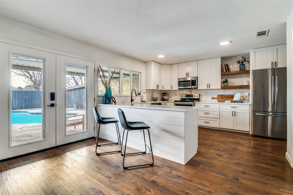 4225 Wayfaring Street Mesquite, TX 75150 - Photo 11 of 26 a kitchen with stainless steel appliances granite countertop a refrigerator a stove top oven a sink and cabinets