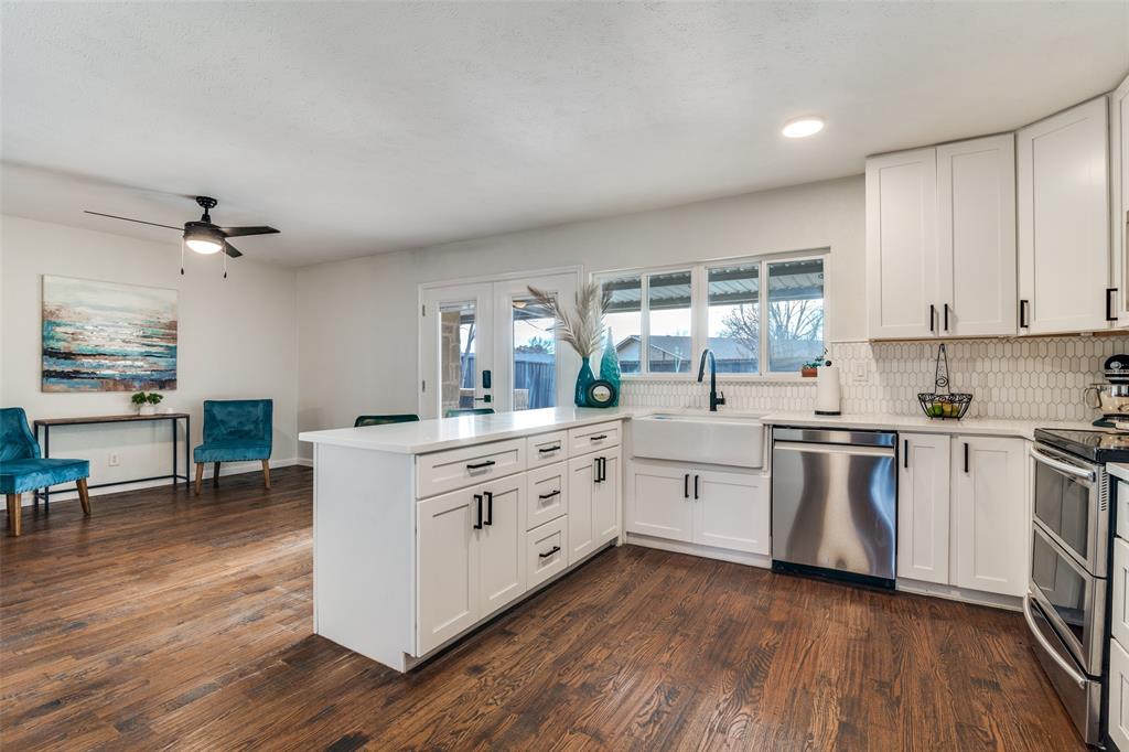 4225 Wayfaring Street Mesquite, TX 75150 - Photo 12 of 26 a kitchen with stainless steel appliances white cabinets and wooden floors