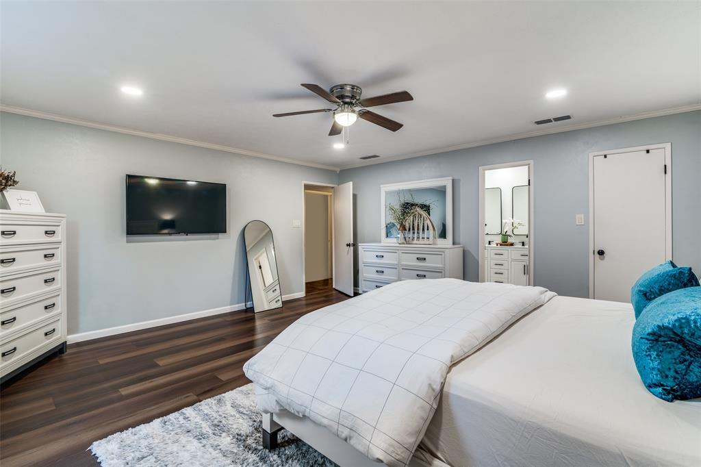 4225 Wayfaring Street Mesquite, TX 75150 - Photo 16 of 26 a spacious bedroom with a bed and a flat screen tv