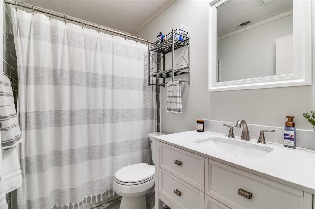 4225 Wayfaring Street Mesquite, TX 75150 - Photo 21 of 26 a bathroom with a sink toilet and shower