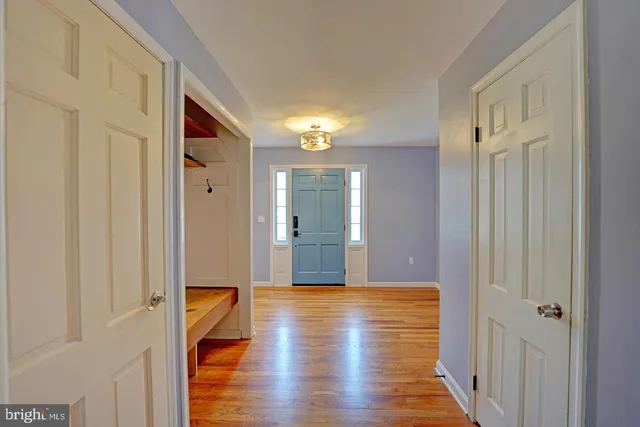 a view of a hallway with wooden floor