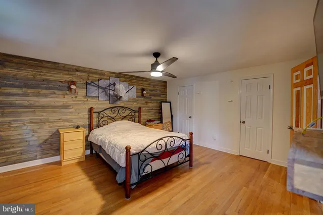 a spacious bedroom with a bed and a chandelier
