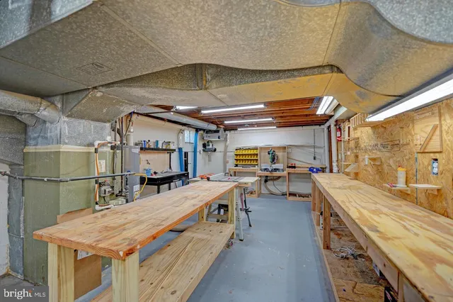 a utility room with stainless steel appliances wooden floor and large windows