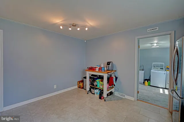 a dining room with furniture a chandelier and wooden floor