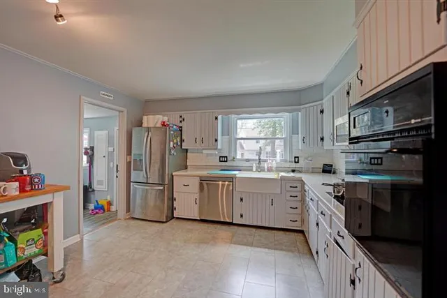 a kitchen with cabinets a sink and appliances