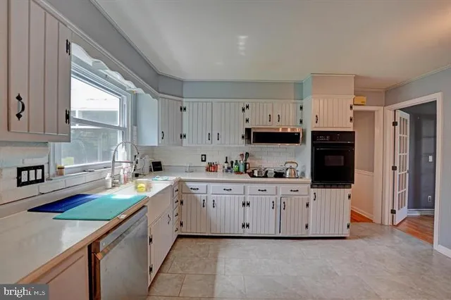 a dining room with wooden floor and glass door
