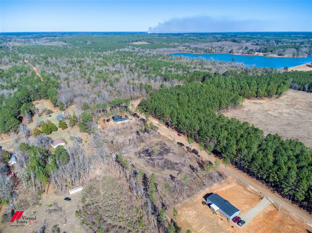 4 Lake Road Plain Dealing, LA 71064 - Photo 8 of 11 a view of a lake with a yard