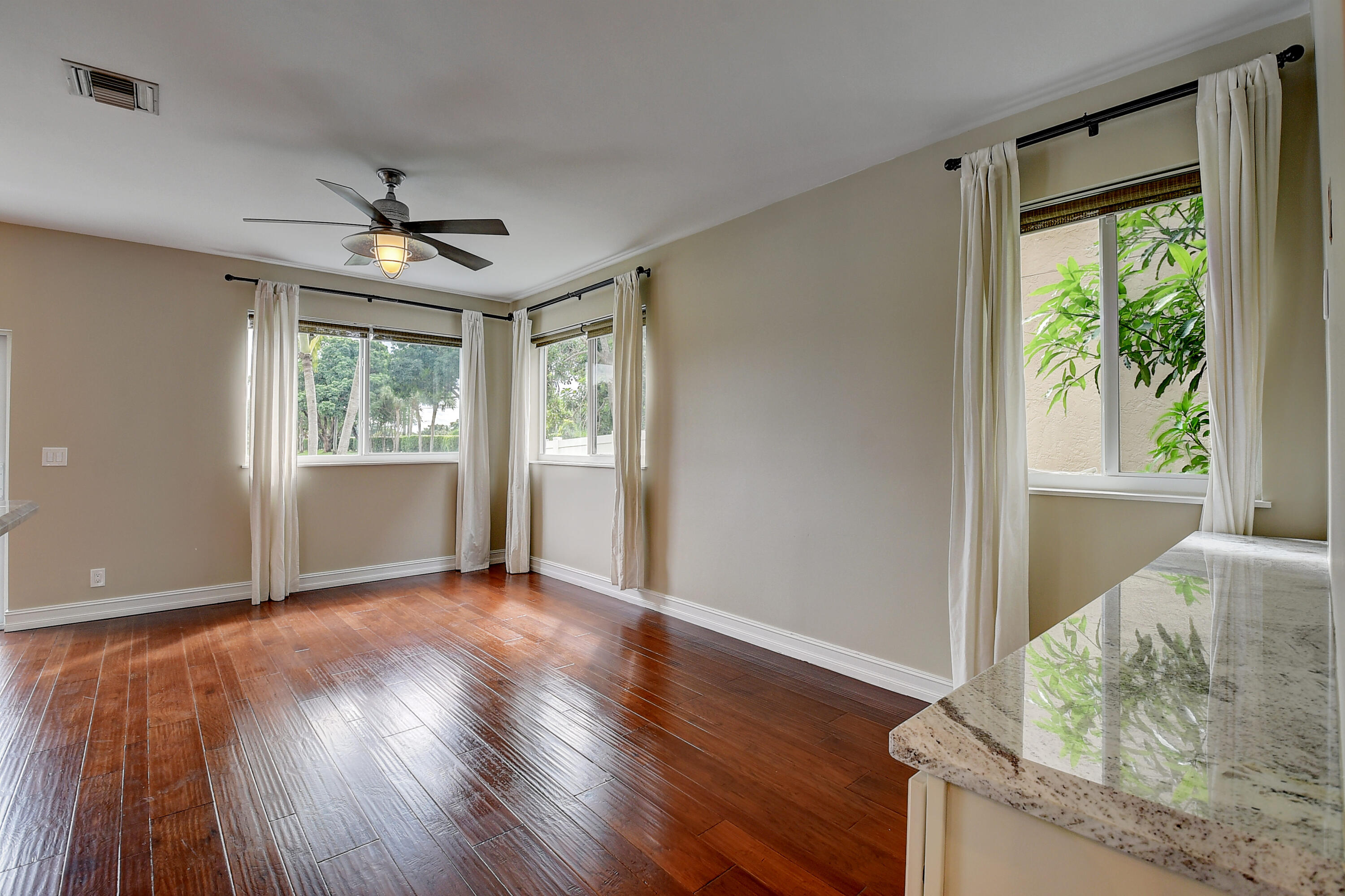 10599 Palm Spring Drive Boca Raton, FL 33428 - Photo 12 of 46 a view of a livingroom with wooden floor and a window