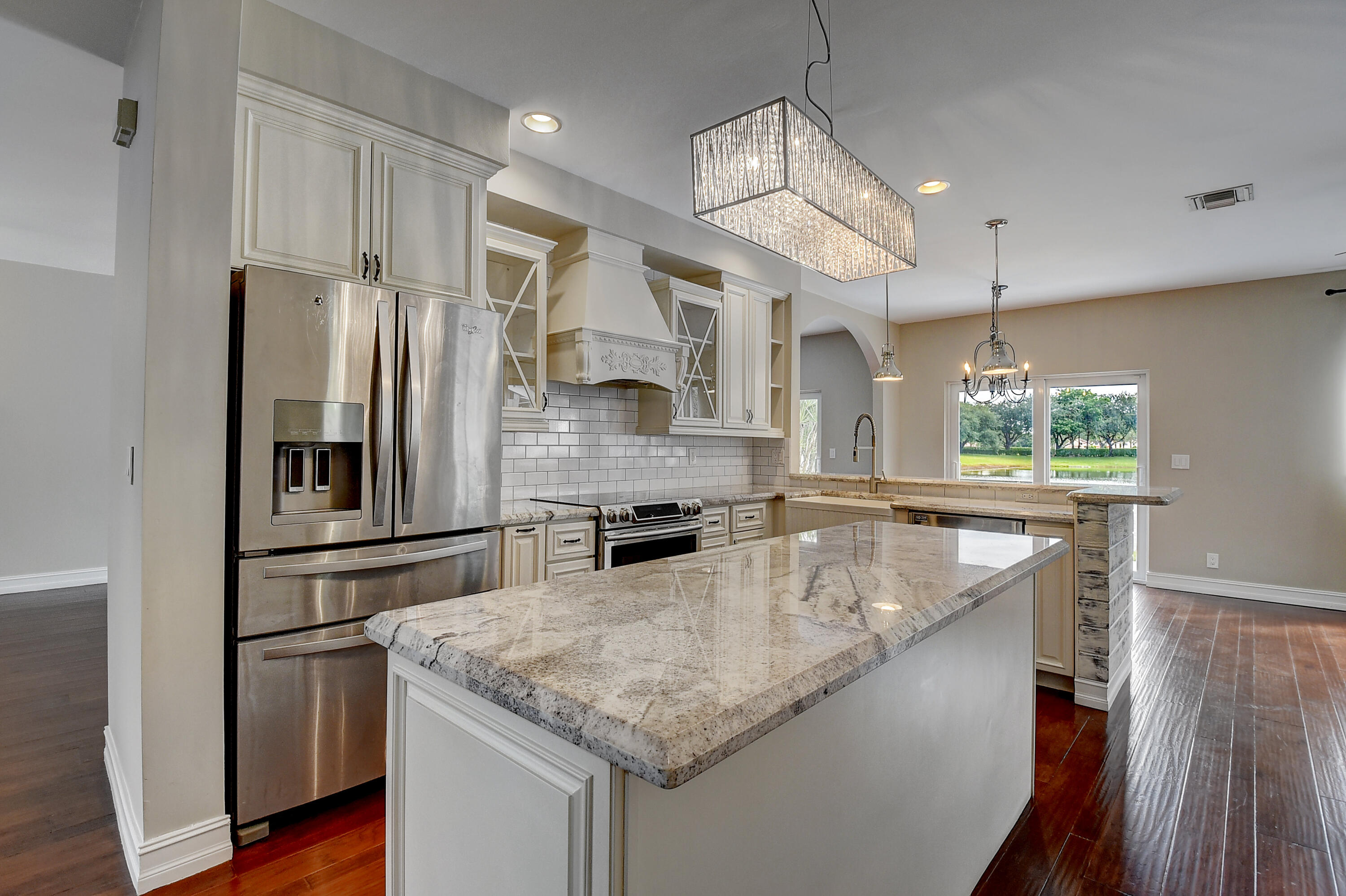 10599 Palm Spring Drive Boca Raton, FL 33428 - Photo 15 of 46 a kitchen with stainless steel appliances granite countertop a sink a stove and a refrigerator