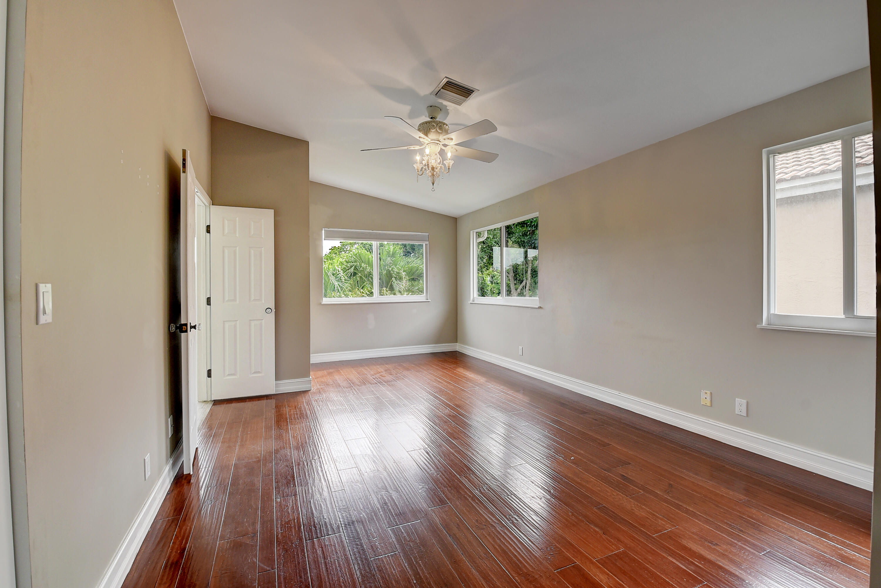 10599 Palm Spring Drive Boca Raton, FL 33428 - Photo 22 of 46 wooden floor in an empty room with a window