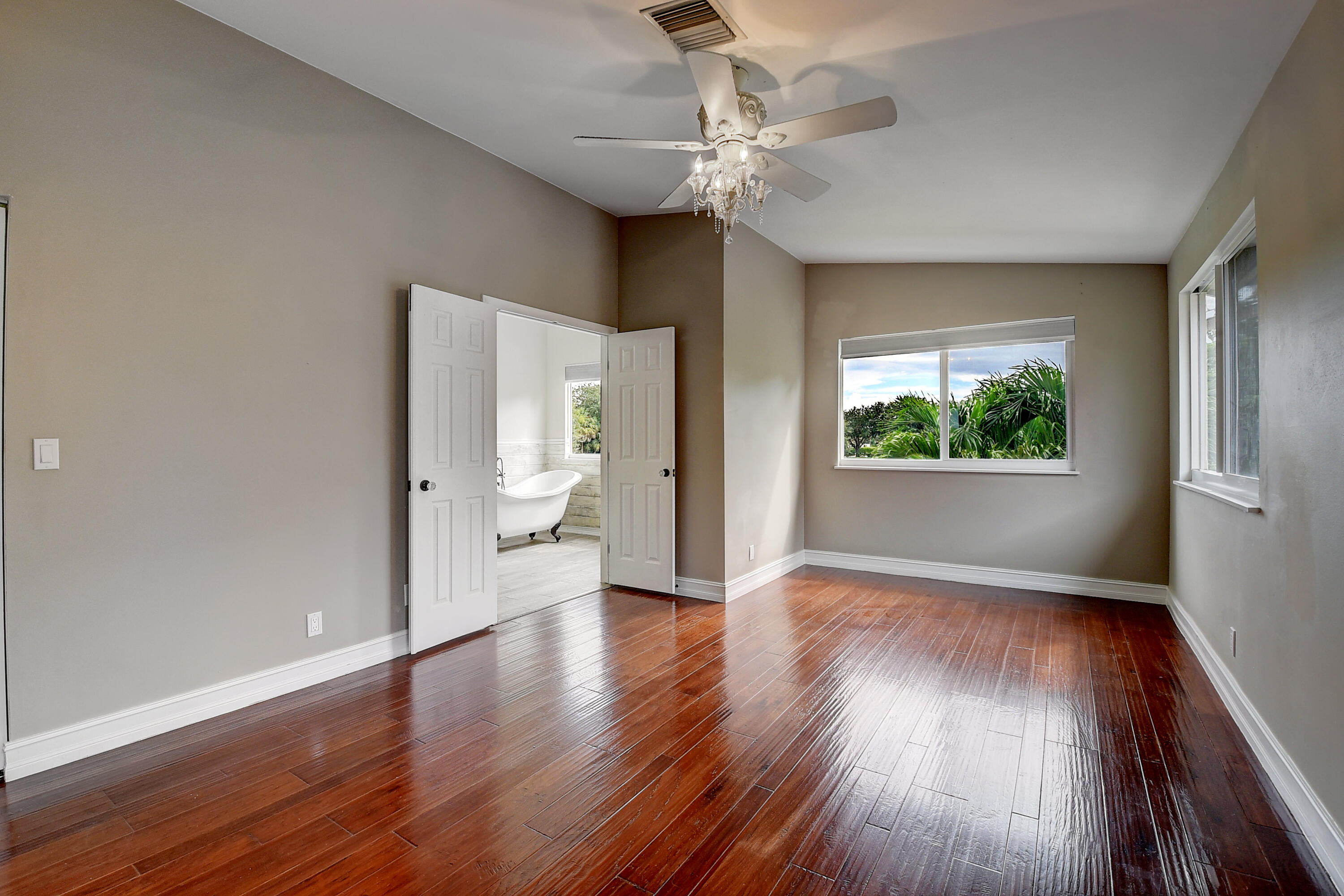 10599 Palm Spring Drive Boca Raton, FL 33428 - Photo 23 of 46 a view of an empty room with wooden floor and a window