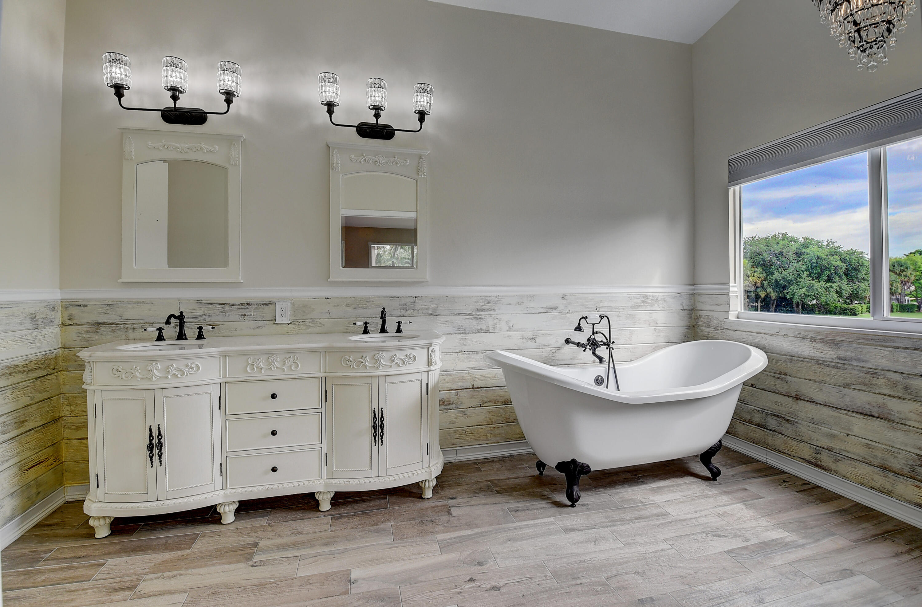 10599 Palm Spring Drive Boca Raton, FL 33428 - Photo 25 of 46 a spacious bathroom with a double vanity sink a mirror and a bathtub