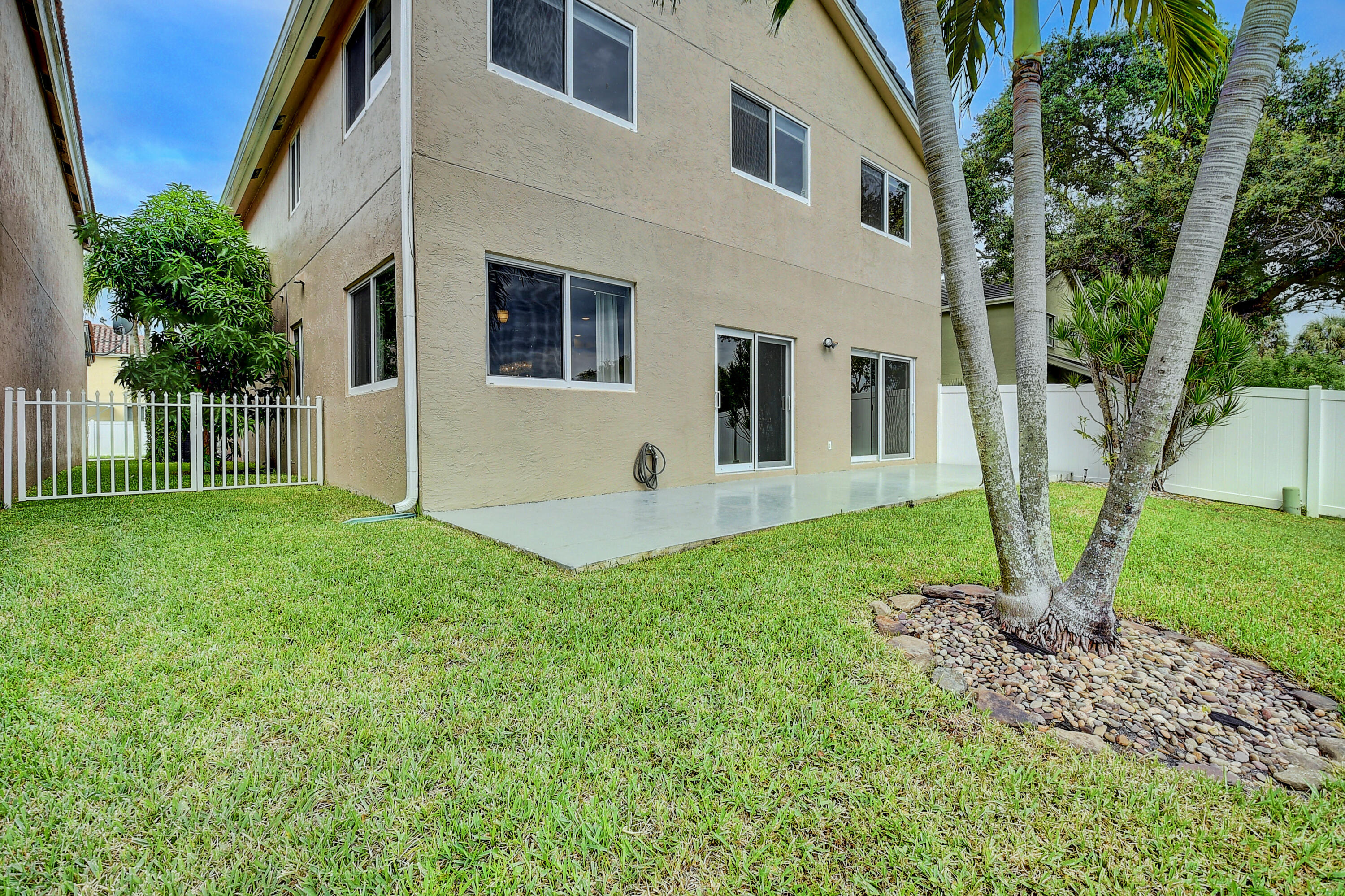 10599 Palm Spring Drive Boca Raton, FL 33428 - Photo 33 of 46 a view of a house with backyard and a tree