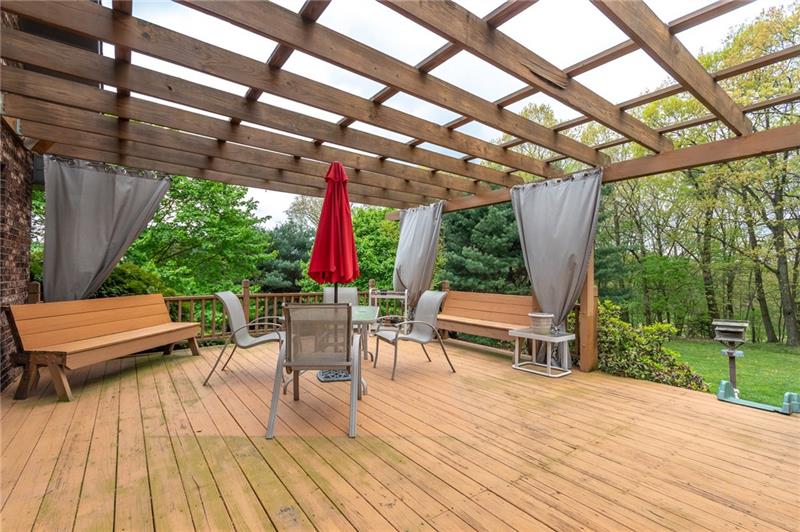 1473 Lovi Road Freedom, PA 15042 - Photo 20 of 22 The 23X17 deck with arbor accent & built-in seating overlooks a lush and beautifully landscaped yard