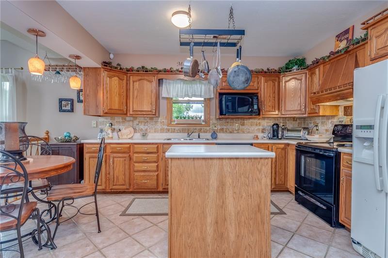 1473 Lovi Road Freedom, PA 15042 - Photo 7 of 22 Bright, airy & open to the main living area, the EIK allows inclusiveness when entertaining - an adjacent pantry offers extra storage.