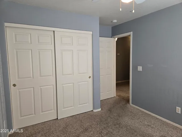 an empty room with closet area