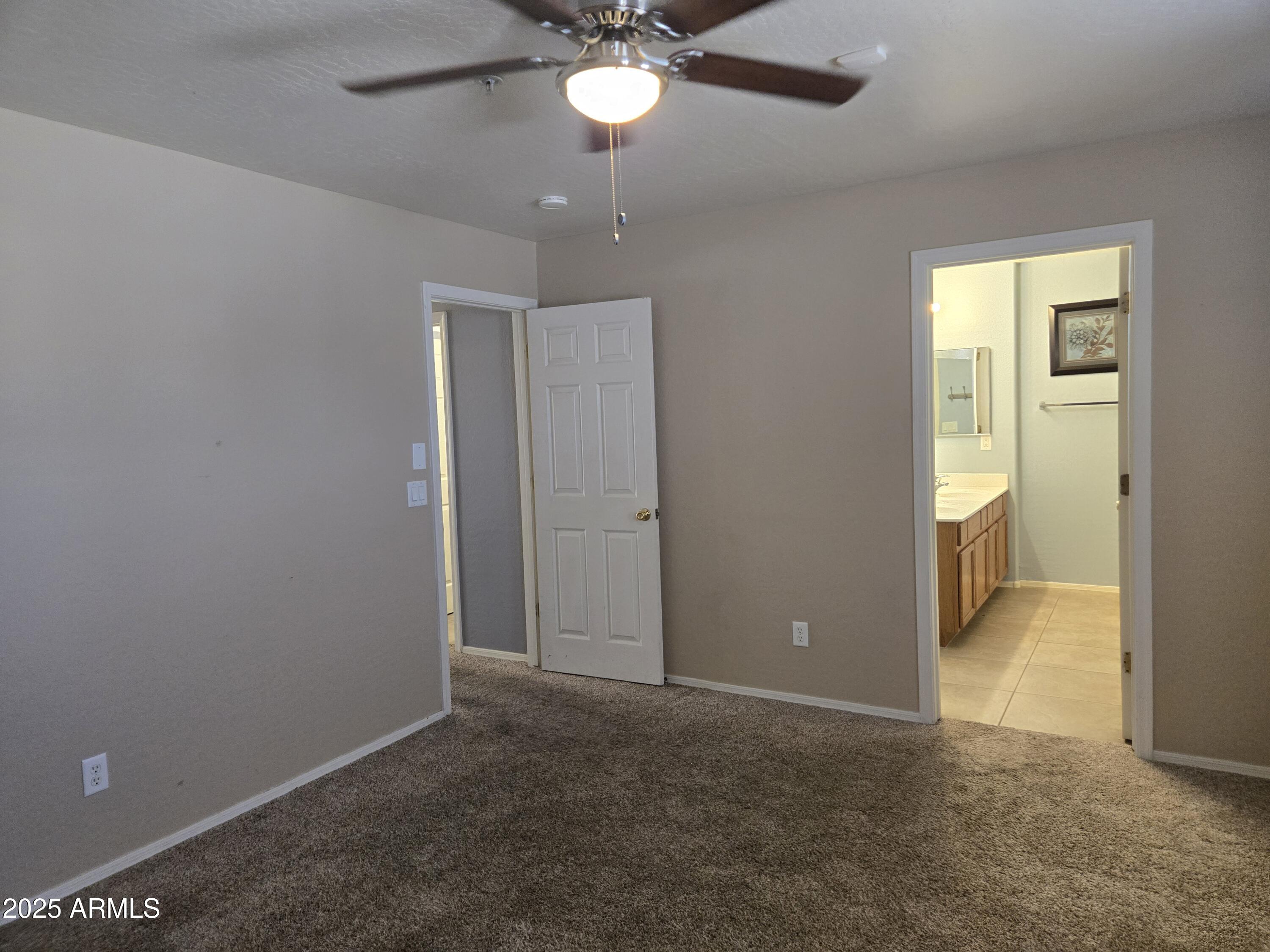 16021 North 30th Street, Unit 119 Phoenix, AZ 85032 - Photo 25 of 28 an empty room with closet and a chandelier fan