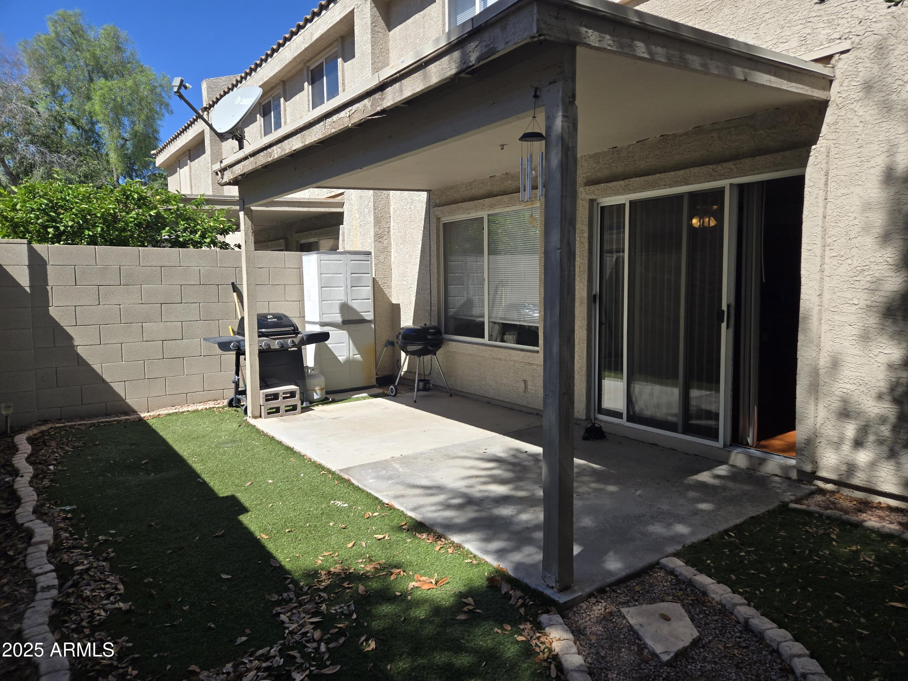 16021 North 30th Street, Unit 119 Phoenix, AZ 85032 - Photo 28 of 28 a patio with table and chairs