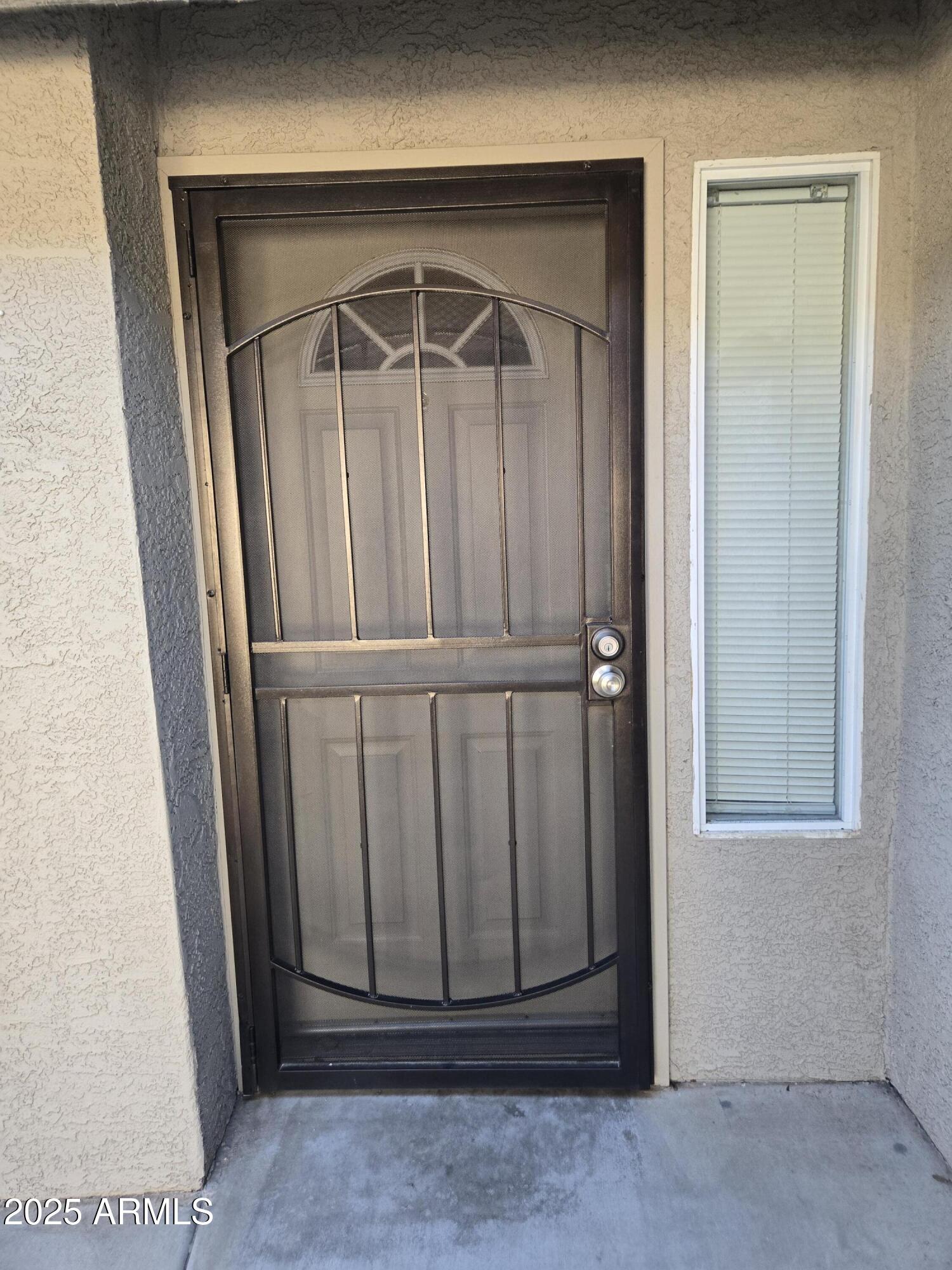16021 North 30th Street, Unit 119 Phoenix, AZ 85032 - Photo 3 of 28 an empty room with wooden door