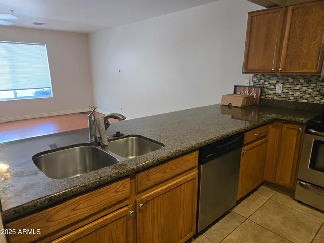 a kitchen with granite countertop a sink and a stove