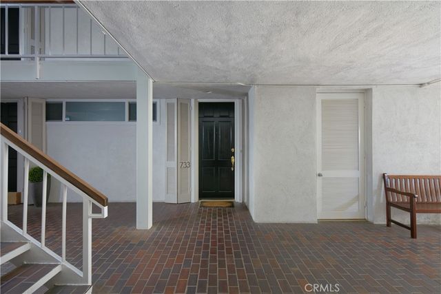 a view of a livingroom with wooden floor and stairs