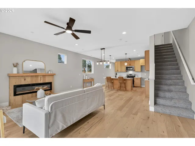 a kitchen with stainless steel appliances kitchen island granite countertop a sink a stove a dining table and chairs