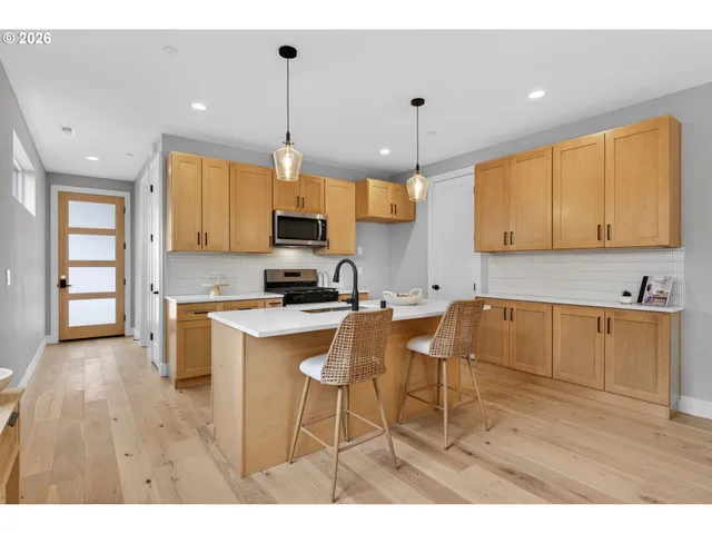 a view of livingroom and dining room with furniture wooden floor