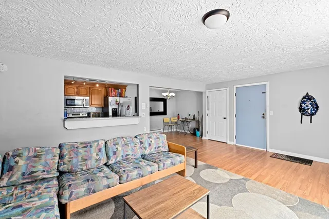 a living room with furniture and wooden floor