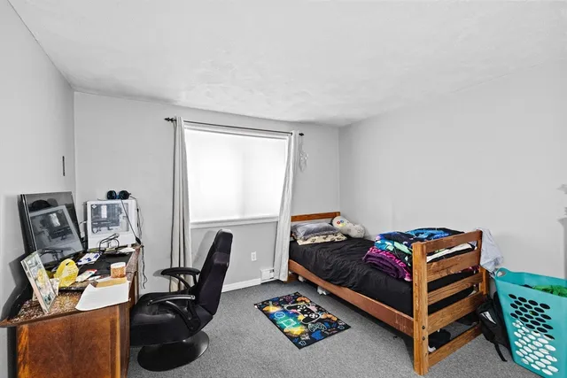 a bedroom with furniture and a window